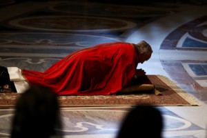 Pope Francis lies on the floor as he presides over a papal mass inside St. Peter's Basilica on Friday in Vatican City. Pope Francis is taking part in his first holy week as pontiff. He caused some controversy during Holy Thursday, when he washed and kissed the feet of two young women — a surprising departure from church rules that restrict the ritual to men. Dan Kitwood/Getty Images