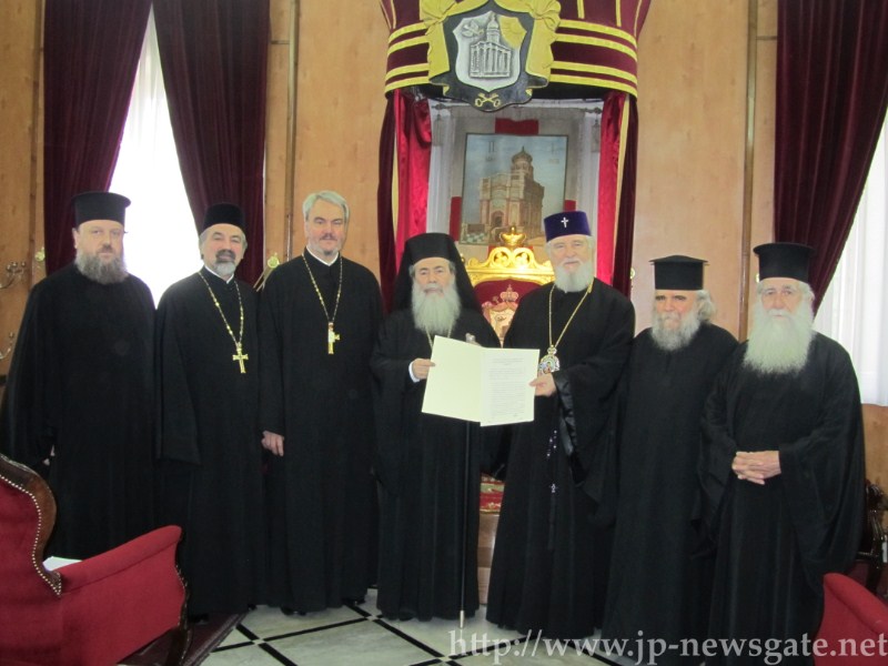 His Beatitude and the Metropolitan of Targoviste holding the signed agreement