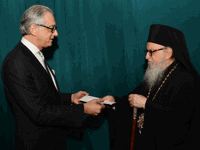 George Tsandikos presents His Eminence Archbishop Demetrios with a Leadership 100 check for $1 million for the building of the St. Nicholas National Shrine.