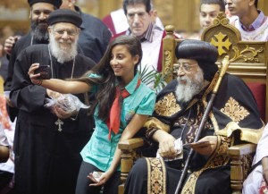 A young copt takes a selfie with Pope Tawadros II of the Coptic Orthodox Church, left, as he was at St Marc’s Coptic Church in Montreal, Saturday, Sept. 20, 2014. Photograph by: Vincenzo D'Alto , The Gazette