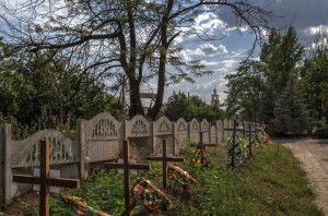 Lining a road leading to a Russian Orthodox church in Slovyansk, Ukraine, are the graves of pro-Russian fighters who died fighting Ukrainian government troops. Credit Mauricio Lima for The New York Times
