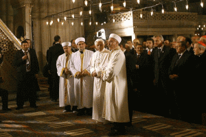 Pope Benedict XVI stands next to Emrullah Hatipoglu, imam of the Blue Mosque, and Mustafa Cagrici, right, the grand mufti of Istanbul, as he visits the Blue Mosque in Istanbul in this Nov. 30, 2006, file photo. The pope's unexpected prayer next to the mu fti in the mosque soothed anger in the Muslim world over a quote about Islam in his Sept. 12, 2006, lecture in Regensburg, Germany. It was only the second time a pontiff had entered a mosque.CNS photo/Patrick Hertzog, pool via Reuters