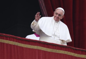 Pope Francis waves as he delivers a "Urbi et Orbi" (to the city and world) message from the balcony overlooking St. Peter's Square at the Vatican December 25, 2014. (Alessandro Bianchi/Reuters)