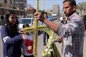 An Egyptian Coptic Christian vendor offers a cross made of weaved palms leaves on Palm Sunday at Heliopolis in Cairo, Egypt, 05 April 2015. EFE/EPA/KHALED ELFIQI