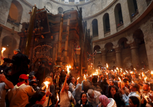 Worshippers hold candles as they take part in the Christian Orthodox Holy Fire ceremony at the Church of the Holy Sepulchre in Jerusalem. (photo credit:REUTERS)
