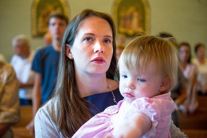 Emily Sullivan holds her daughter, Mary Kathleen, during mass at Saint Andrew Catholic Church in Newtown, Pa.  Ann Hermes/The Christian Science Monitor