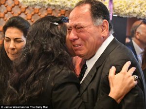 Perfect daughter: The parents of Yara Hani Tawfik embrace as they mourn her passing during her funeral