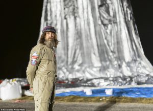In this Monday, July 11, 2016 photo released Wednesday, July 20, 2016 by Morton, Russian adventurer Fedor Konyukhov stands by his helium and hot-air balloon being inflated before liftoff on his record attempt to fly solo in a balloon around the world nonstop in Northam in Western Australia state. Konyukhov, 65, now flying at more than 6,000 meters (20 feet) above the ground, was battling sleep deprivation, freezing temperatures and ice in his oxygen mask as he nears the end of his record attempt to fly solo around the world nonstop, his son said on Wednesday, July 20, 2016. (Oscar Konyukhov/Morton via AP)