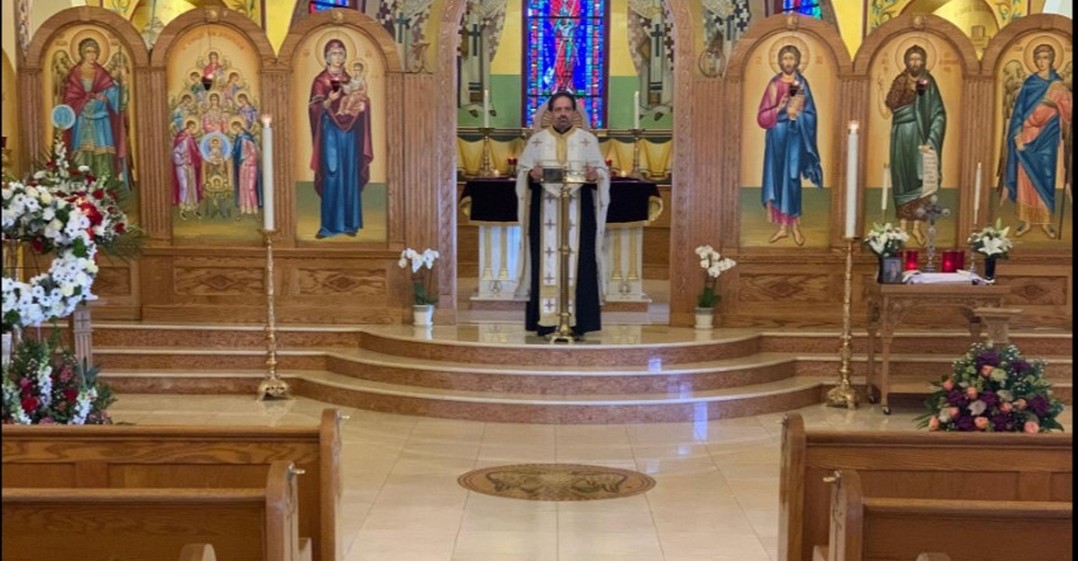 Standing before rows of empty pews at the closed Taxiarchae Archangels ...